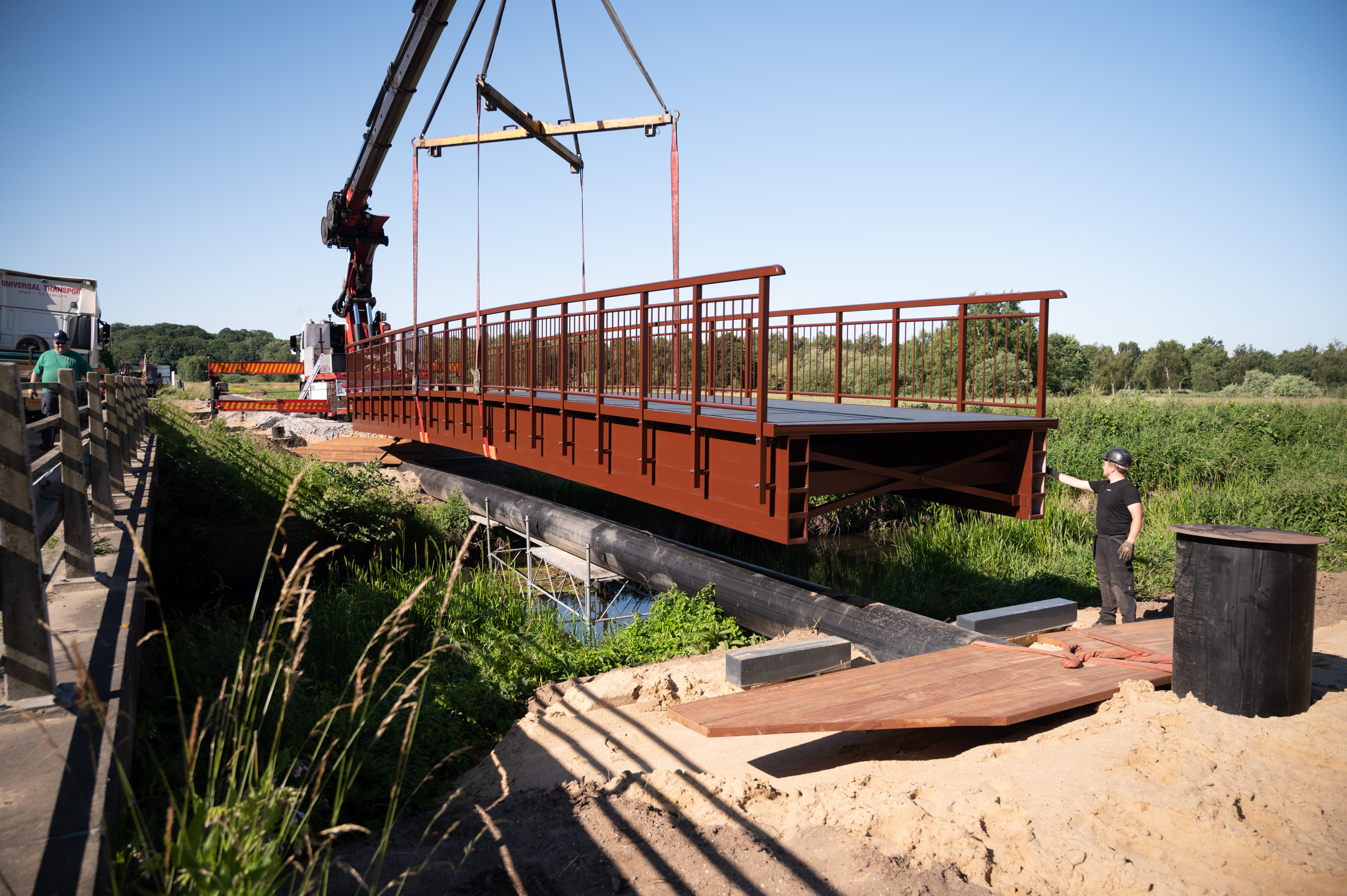 Fiberline bridge being liftet in place with a crane